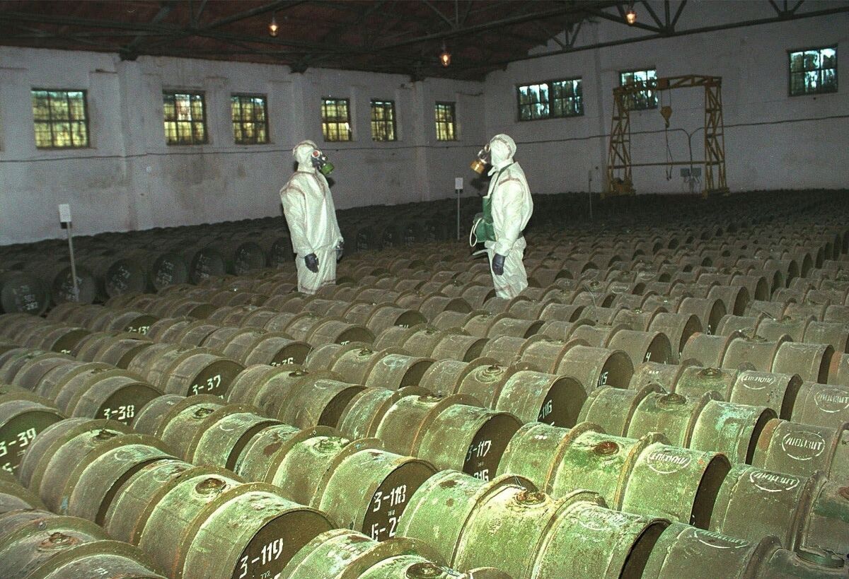 FILE - In this Saturday, May 20, 2000 file photo, two Russian soldiers make a routine check of metal containers with toxic agents at a chemical weapons storage site in the town of Gorny, 124 miles (200 kms) south of the Volga River city of Saratov, Russia. Novichok, a deadly nerve agent that has left Russian opposition politician Alexei Navalny in a coma and nearly killed a former Russian spy and his daughter in 2018, was the product of a highly secretive Soviet chemical weapons program. Just a few milligrams of the odorless liquid — the weight of a snowflake — are enough to kill a person within minutes. (AP Photo, File)