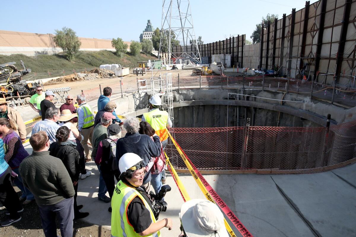 Locals visit the site where an earth pressure balance tunnel boring machine will be used to create a large tunnel, during open house for the L.A. Water Infrastructure project, at Johnny Carson Park South, in Burbank on Saturday, Feb. 8.
