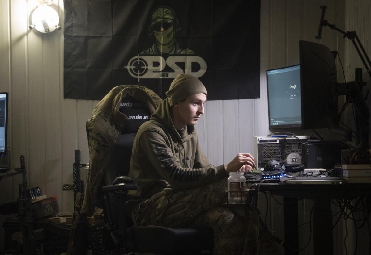 A Ukrainian officer at a computer.