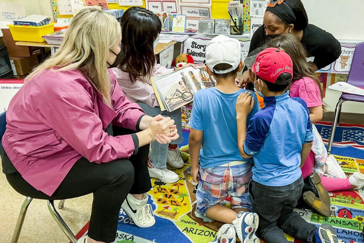 Volunteers read to children during a Reading to Kids event