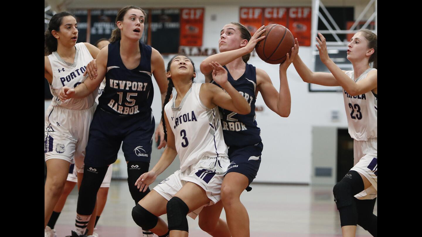 Newport Harbor High's Emma Fults, right, grabs an offensive rebound against Portola during the first half in the Hawk Holiday Classic at Los Amigos High on Wednesday, December 5, 2018.