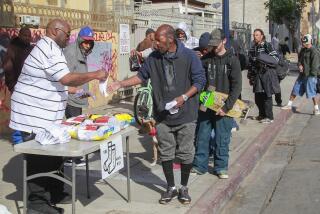 SAN DIEGO, CA February 12th, 2019 | The San Diego Sock Man Hal Sadler hands out socks and message of love to people near 17th Street and Imperial Avenue on Tuesday morning in San Diego, California. A thankful Sadler, who was formerly homeless, wants to give back to the community. | (Eduardo Contreras / San Diego Union-Tribune)
