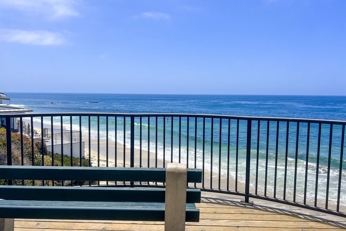 An empty bench on the staircase leading down into Oak Street beach.