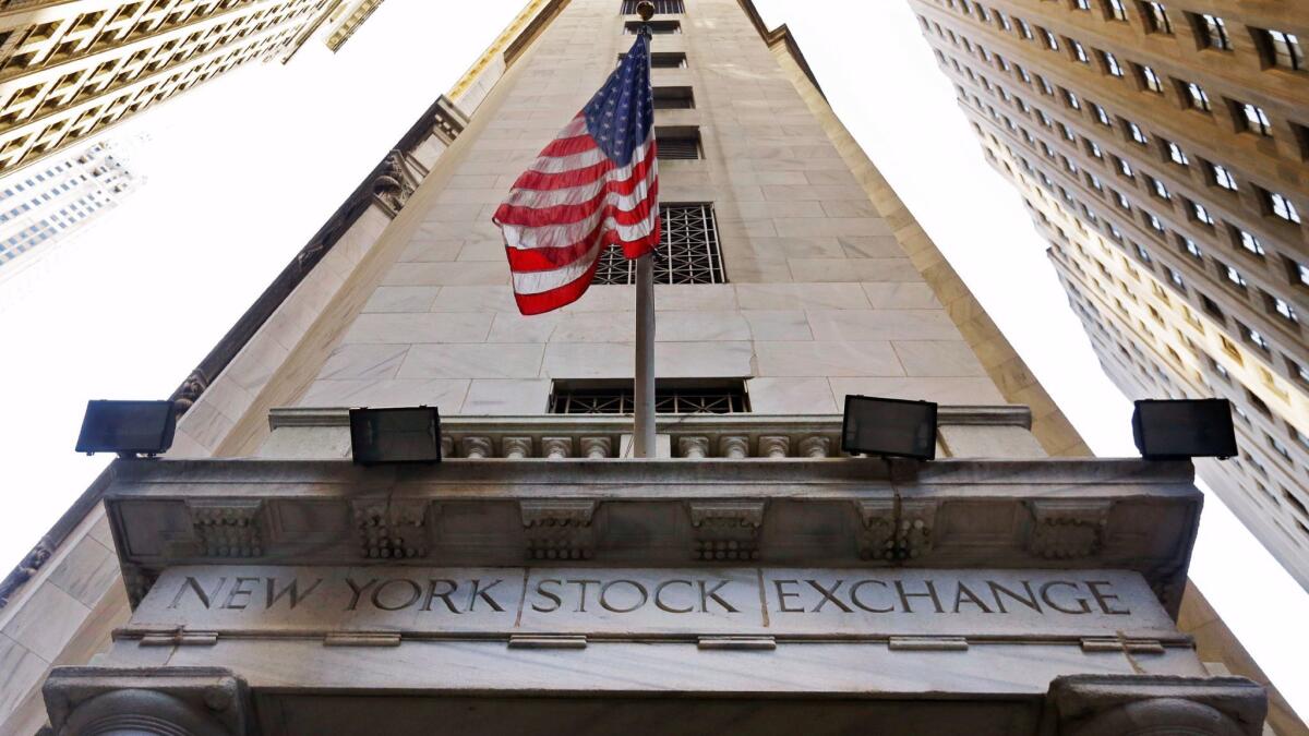 The American flag flies above the Wall Street entrance to the New York Stock Exchange on Nov. 13, 2015.