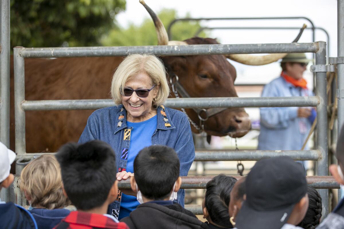 Westminster resident Carol Bills, a new Centennial Farms volunteer, tries her hand at leading a oxen presentation Thursday.