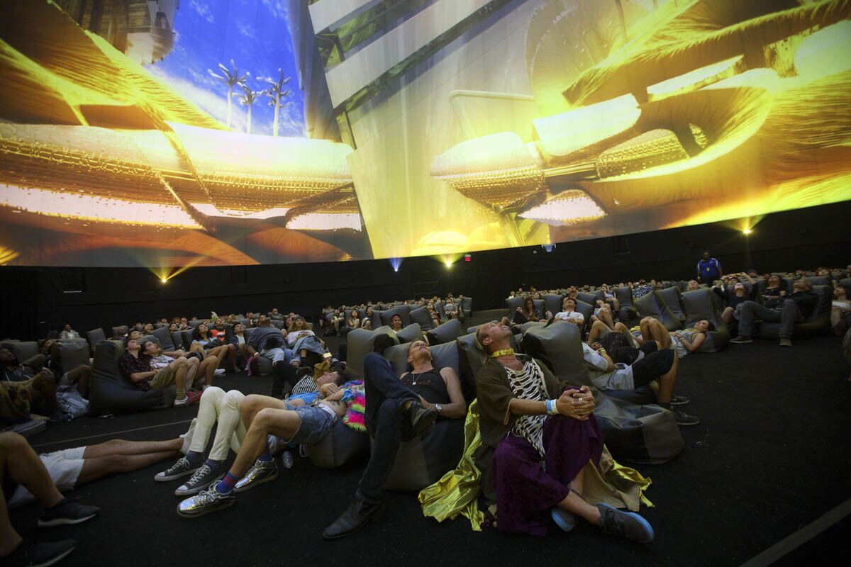 From left, Steve Clohset, Jeff Templeton, Rick Michael, and Jerry Deal, of Obscura Digital, center right, watch The Antarctic powered by HP, a 360 degree sensory experience inside a large-scale projection dome during weekend one of the three-day Coachella Valley Music and Arts Festival at the Empire Polo Grounds on Saturday, April 15, 2017 in Indio, Calif. (Patrick T. Fallon/ For The Los Angeles Times)