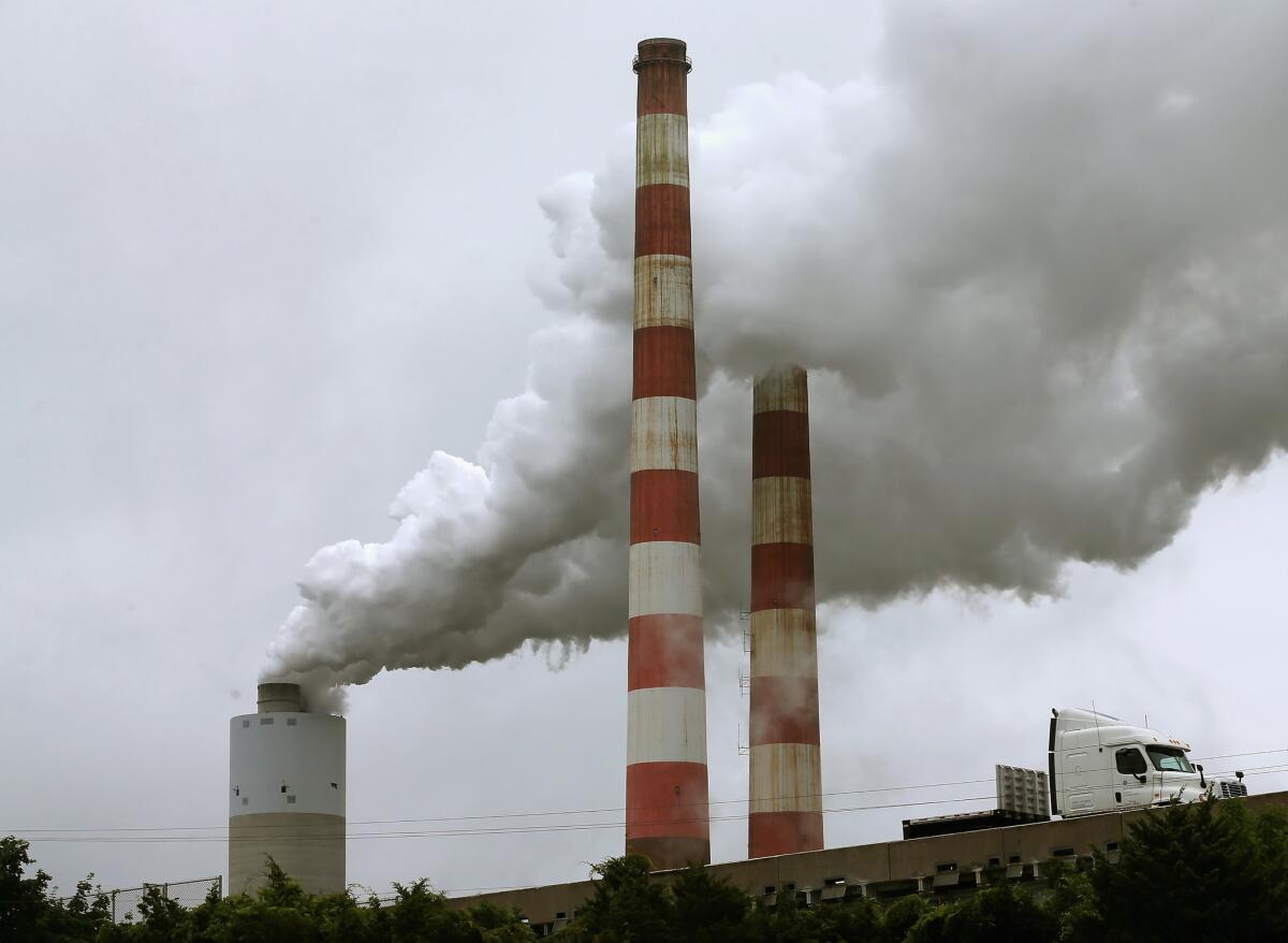 Emissions spew from a large stack at the coal-fired Morgantown Generating Station in Newburg, Md.