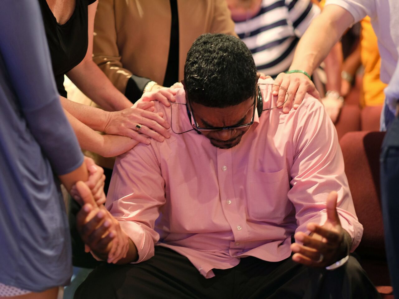 Keith McDaniel, pastor of Macedonia Missionary Baptist Church, is surrounded by others in prayer for the victims of Wednesday's shooting at Emanuel AME Church in Charleston, S.C.