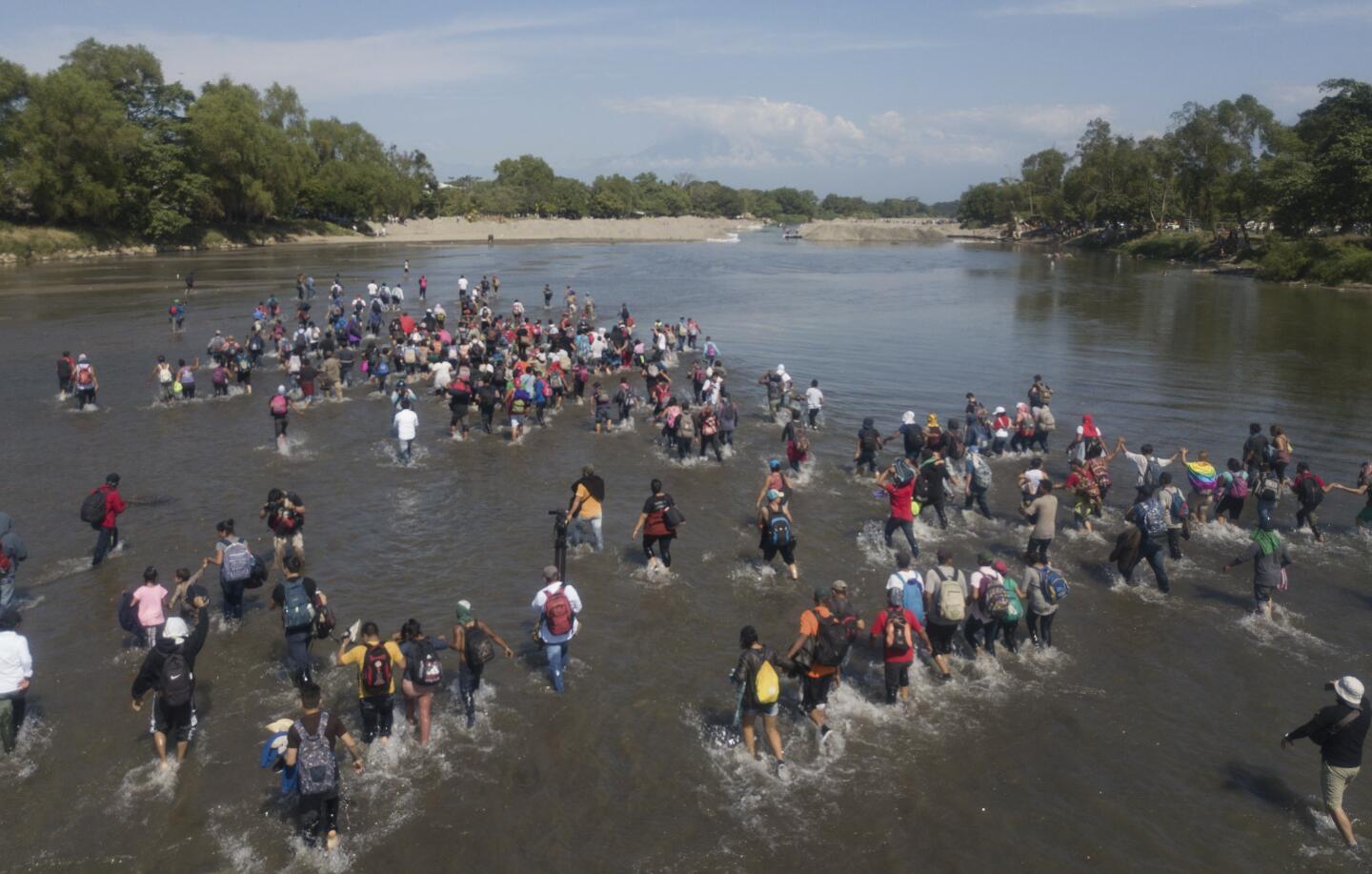 Central American migrants cross the Suchiate River by foot from Tucun Uman, Guatemala, to Mexico.