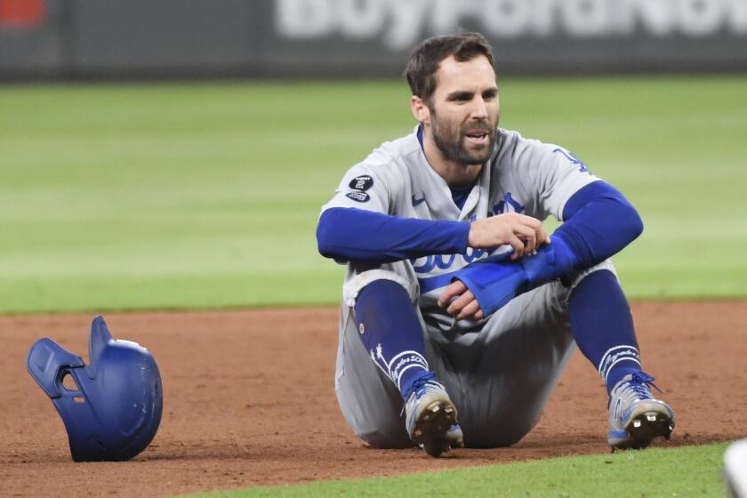 Atlanta, GA - October 16: Los Angeles Dodgers' Chris Taylor sits on the field after being caught in a rundown.