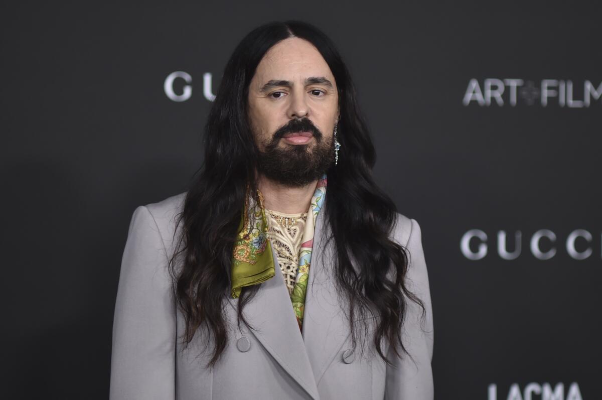 A man with long dark hair and a beard