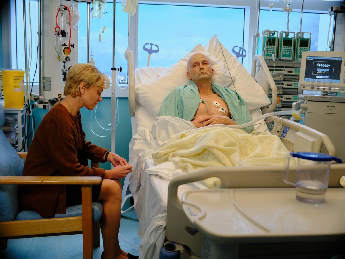 David Tennant in a hospital bed as Alexander Litvinenko, while Margarita Levieva as Marina Litvinenko sits nearby.
