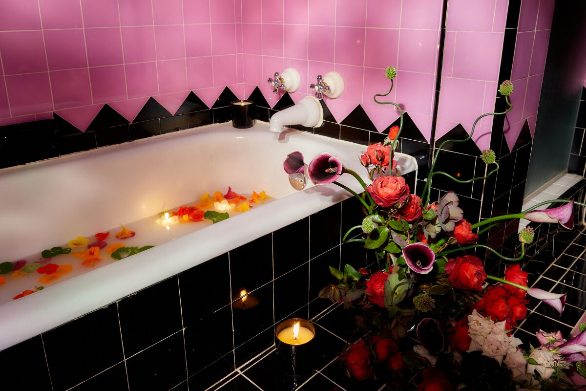 A pastel purple, black and white-tiled art deco bathroom