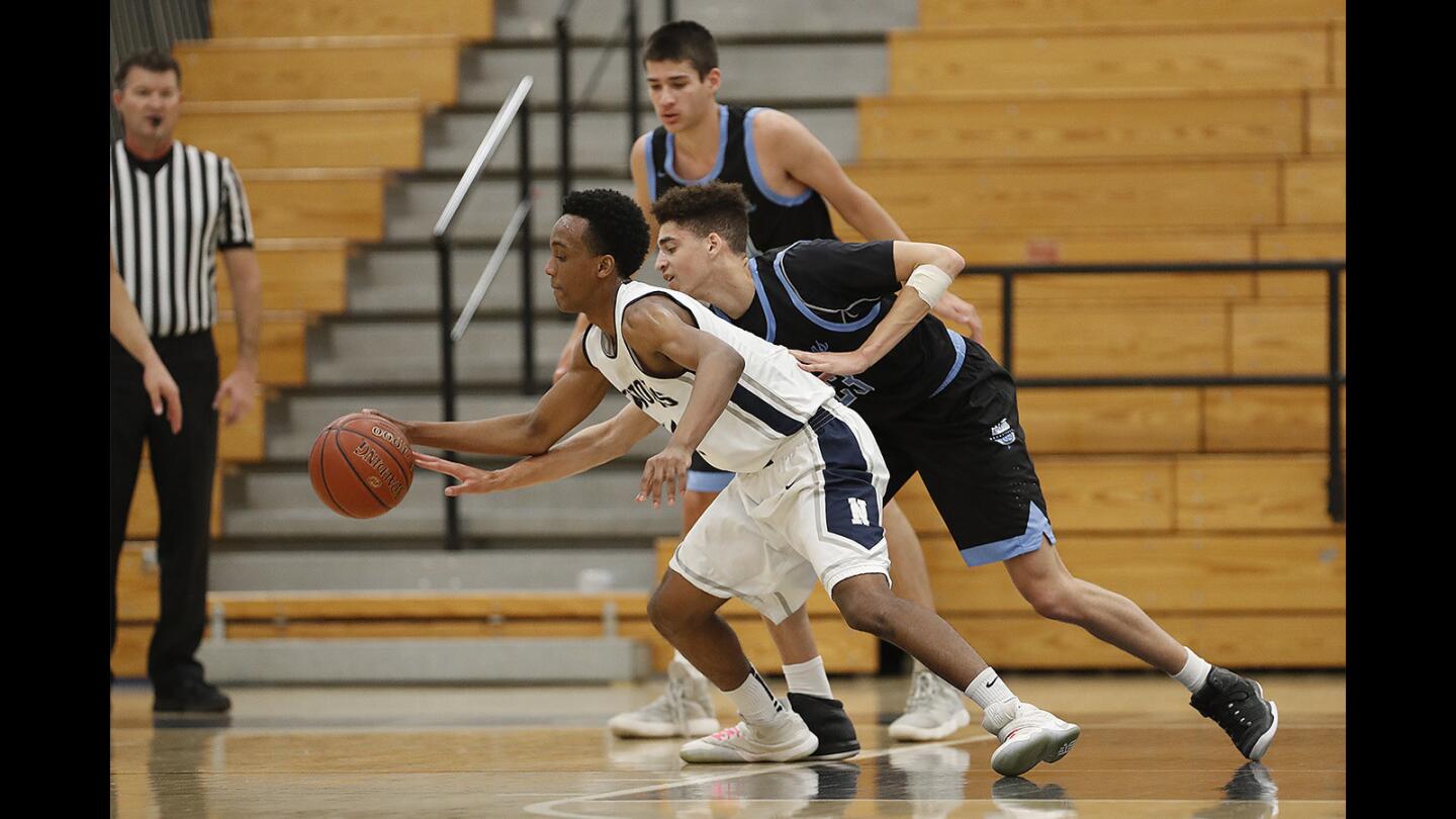 Corona del Mar's Kevin Kobrine puts pressure on Northwood's Devin Owens during a Pacific Coast League game on Thursday, February 1.