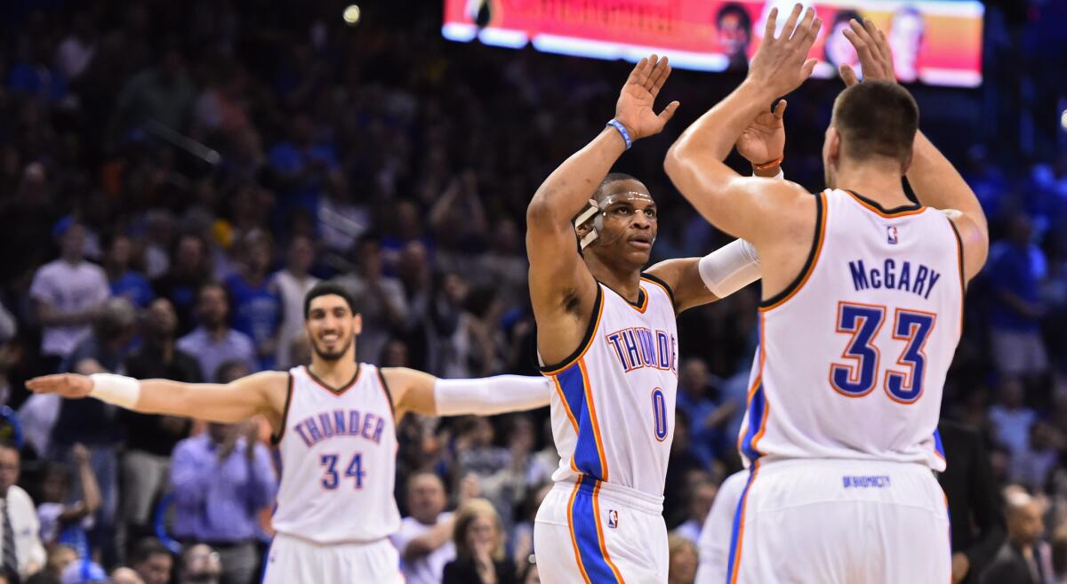 Oklahoma City guard Russell Westbrook celebrates with Thunder forward Mitch McGary after first half dunk against the Lakers during a game on Tuesday.