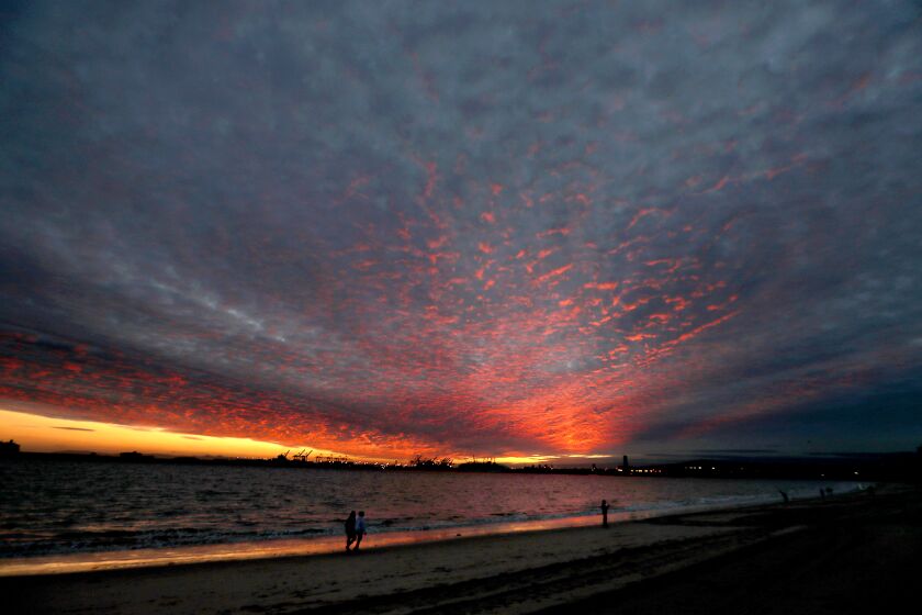 LONG BEACH, CA. - JAN. 27, 2021. The setting sun paints the clouds coming ashore in L:ong Beach ahead of a powerful storm that is expected to hit Southern Califronia tonight, Jan. 27, 2021. (Luis Sinco/Los Angeles Times)