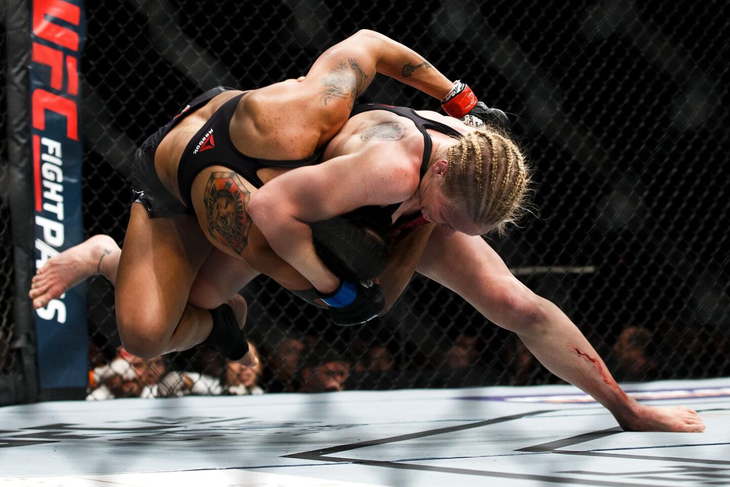 Valentina Shevchenko tries to take down Amanda Nunes during their bout at UFC 215.