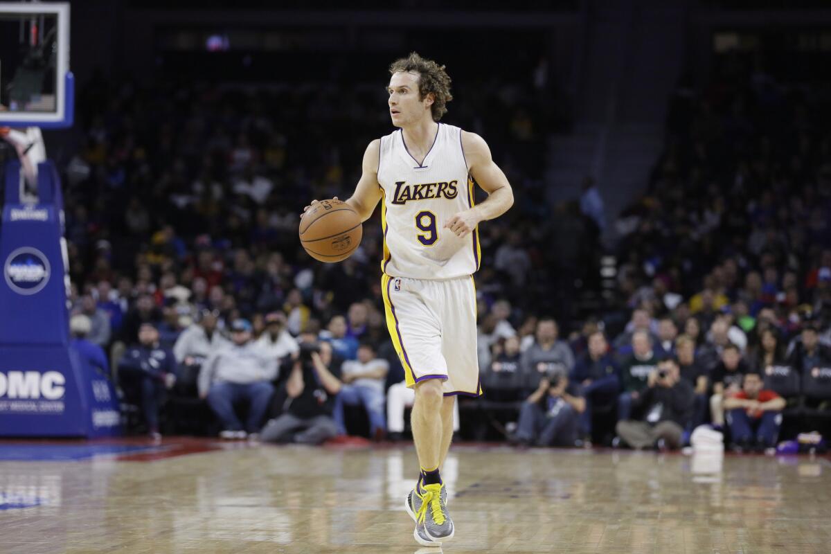 Lakers guard Marcelo Huertas (9) brings the ball up court during the second half.