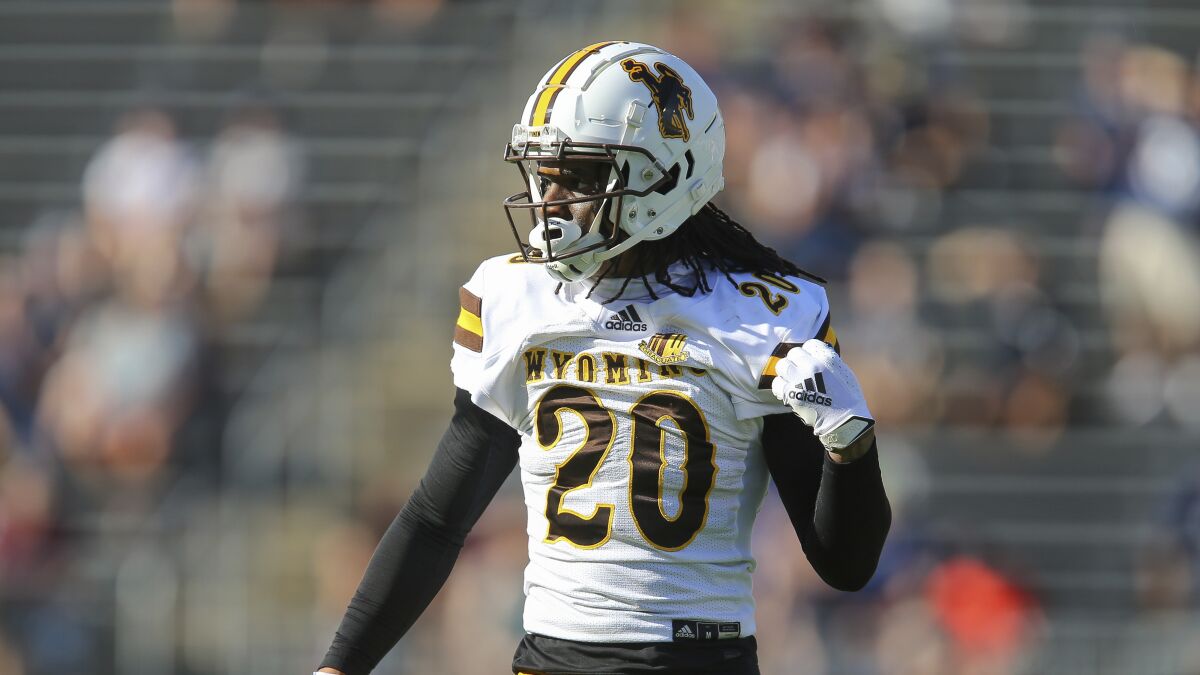 Wyoming cornerback Azizi Hearn (20) defends during the first half of an NCAA football game against Connecticut. 