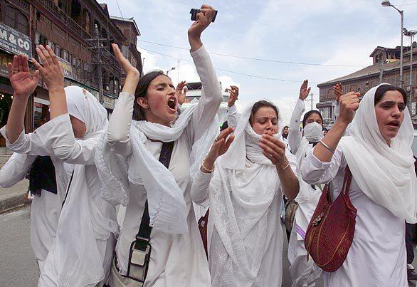 Kashmiri students stage a demonstration in Srinagar, India, even as separatist groups ended a weeklong strike called to protest the deaths of two young women.