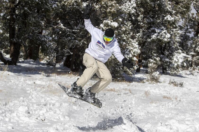BIG BEAR LAKE, CA - DECEMBER 29: With the local ski area sold out and the parking lot full, Jake Kentner, 20, of Vista, backcountry snowboards with friends in some fresh snow in the San Bernardino Mountains on Tuesday, Dec. 29, 2020 in Big Bear Lake, CA. (Brian van der Brug / Los Angeles Times)