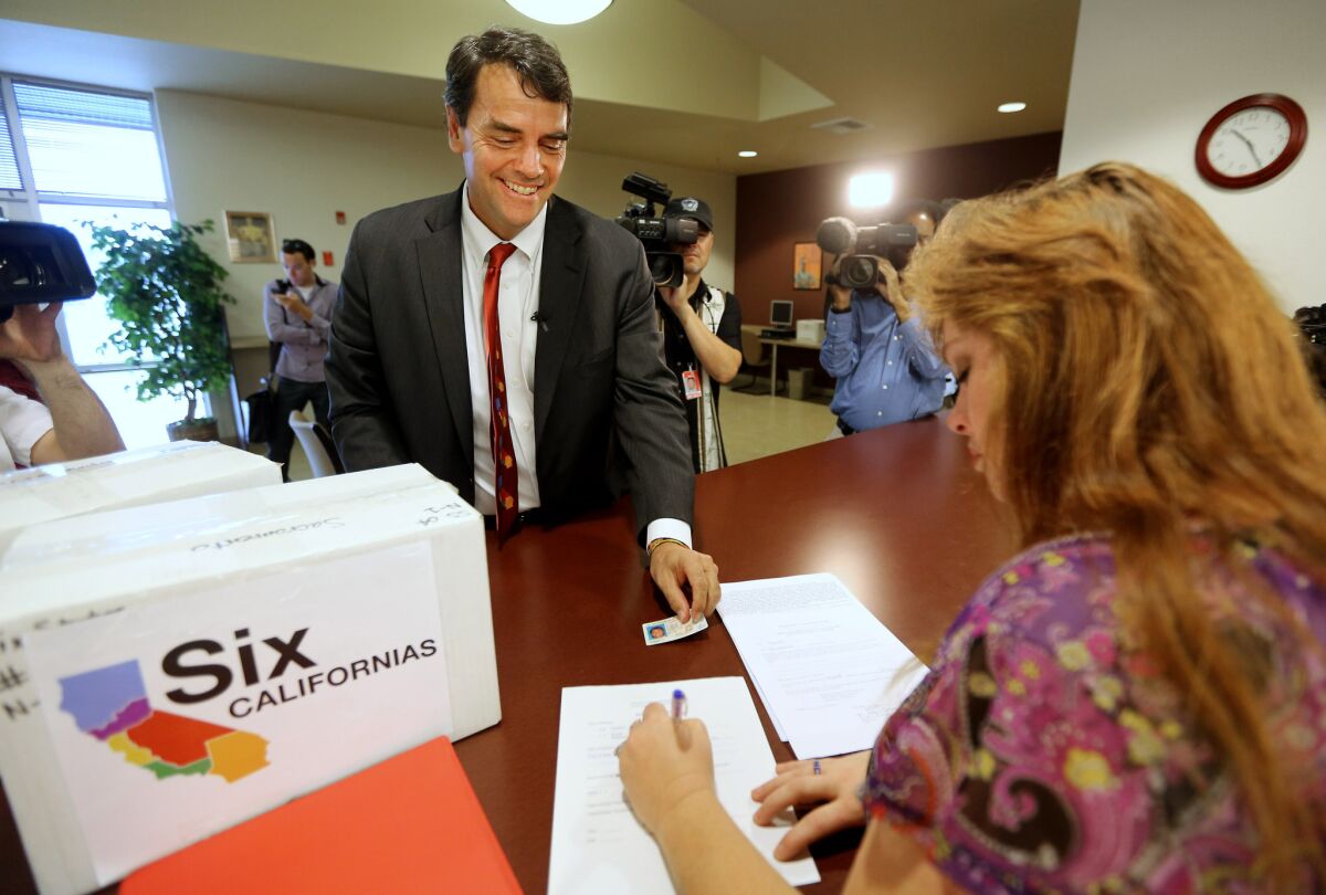 A plan to split California into six states has failed to qualify for the ballot. Its proponent, venture capitalist Tim Draper, is shown submitting petitions for the initiative in July.