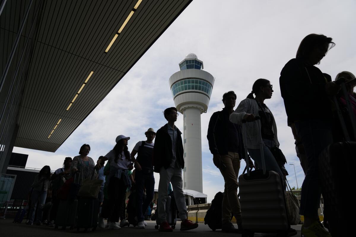 Travelers at Amsterdam's Schiphol Airport on Tuesday.