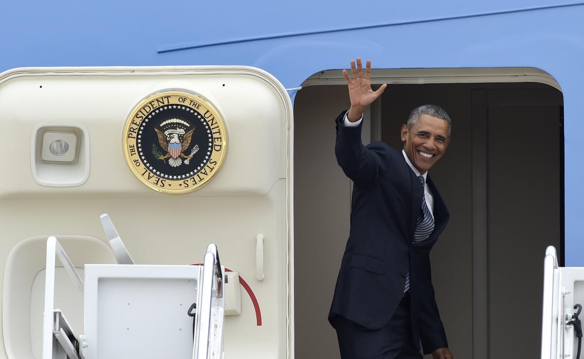 President Barack Obama waves from the top of the steps of Air Force One at Andrews Air Force Base on Monday before beginning a three-day trip to Alaska.