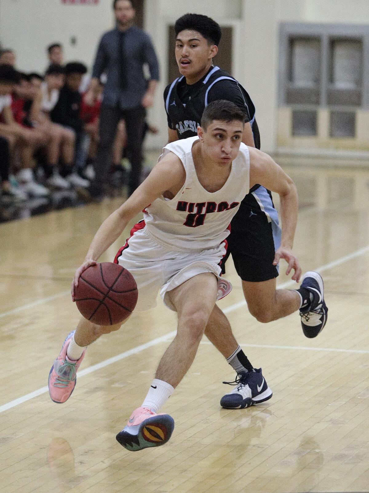 Glendale High boys' basketball player Manny Kapoushian drives to the basket against Salesian in a CIF Southern Section Division III-AA second-round playoff game Friday at Glendale. Glendale fell, 55-49, in overtime.