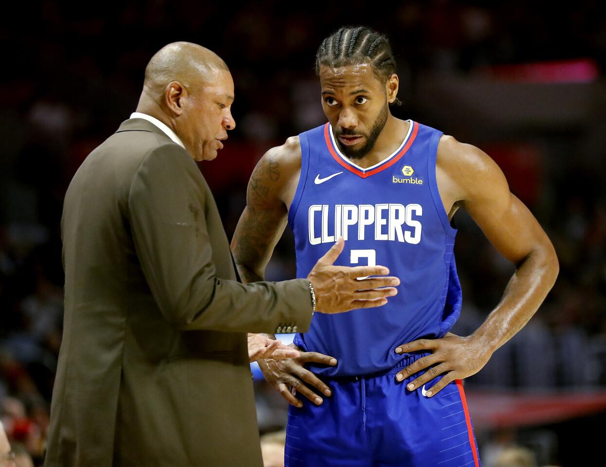 Clippers coach Doc Rivers speaks with forward Kawhi Leonard.