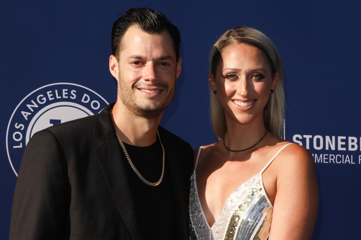 Joe and Ashley Kelly smile at an event.