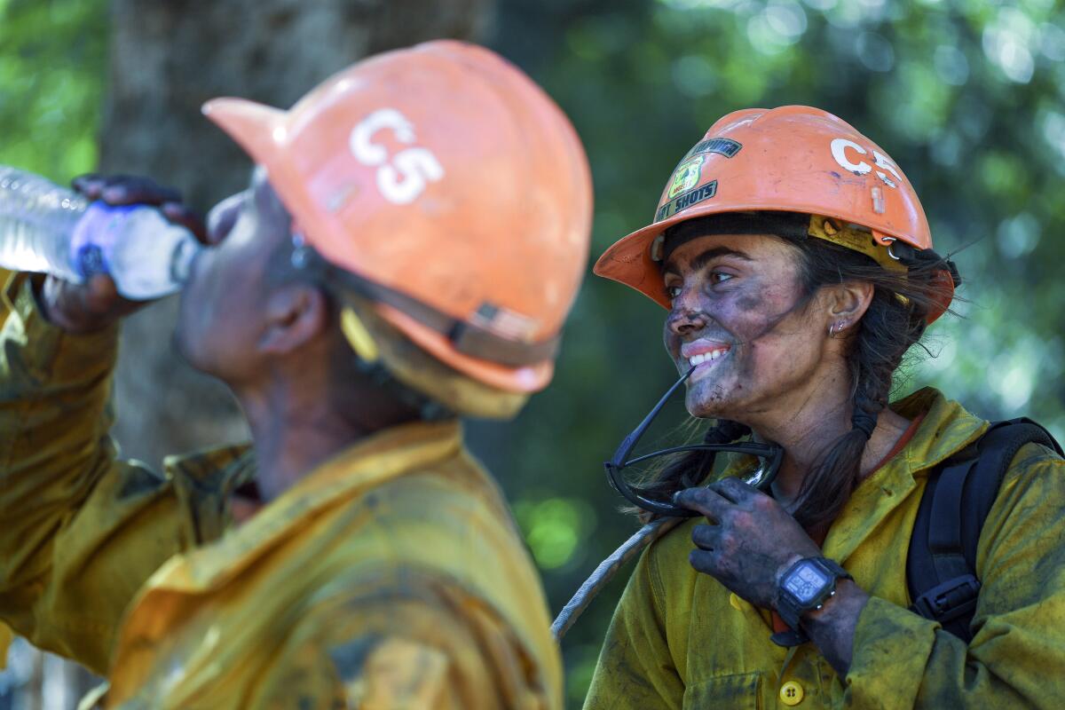 Members of the Little Tujunga Hot Shots take a break after fighting the Willow Fire near the Tassajara Zen Mountain Center in Carmel Valley, Calif., Wednesday, June 23, 2021. (AP Photo/Nic Coury)