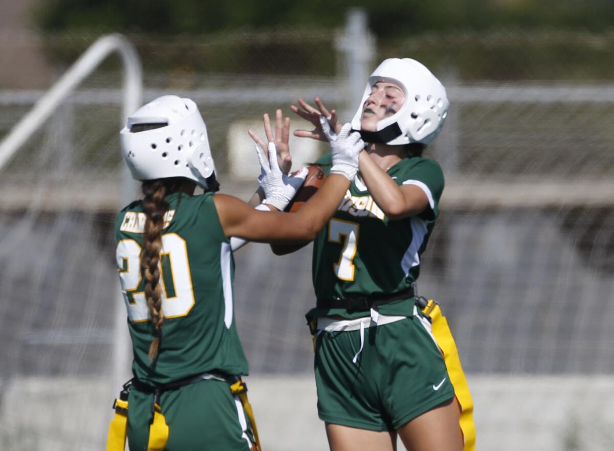 Edison's Emma Valenzuela (7) celebrates with Harlee Thomas after a touchdown against Huntington Beach on Wednesday.