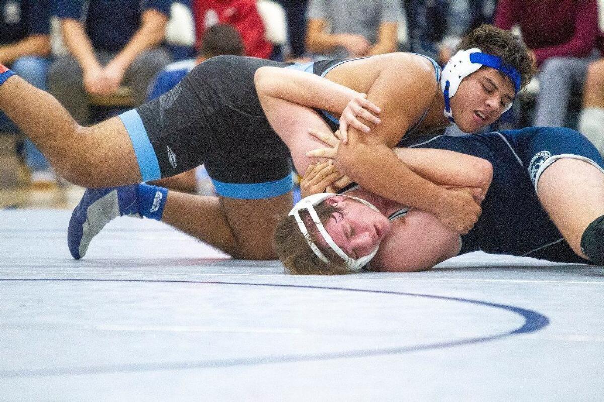 Corona del Mar's Emilio Franco attempts to pin Newport Harbor's J.J. Perez in the 220-pound weight class in a Wave League match on Jan. 9.