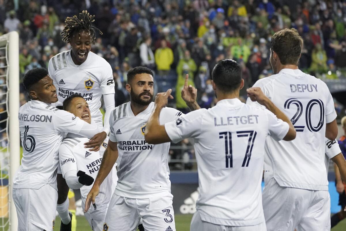 Galaxy forward Javier Hernandez celebrates with teammates after he scored against the Sounders