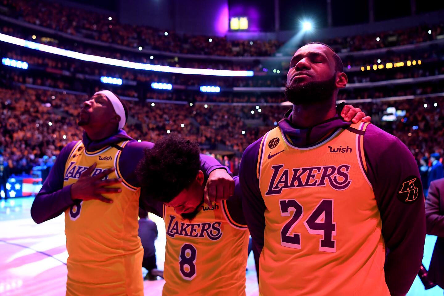 Kentavious Caldwell-Pope, Quinn Cook, and LeBron James close their eyes during a tribute to Kobe Bryant on Jan. 31 at Staples Center.