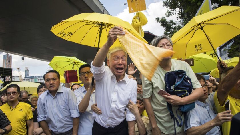 Protesters rally outside court in support of "Umbrella Movement" leaders who were sentenced to prison in Hong Kong on Wednesday.