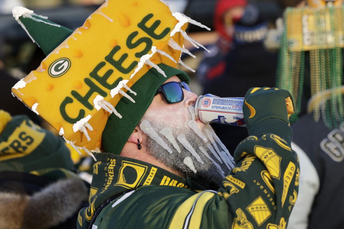 A Green Bay Packers fan tailgates before the start of an NFL football game between the Detroit Lions and Green Bay Packers Sunday, Jan. 8, 2023, in Green Bay, Wis. (AP Photo/Mike Roemer)