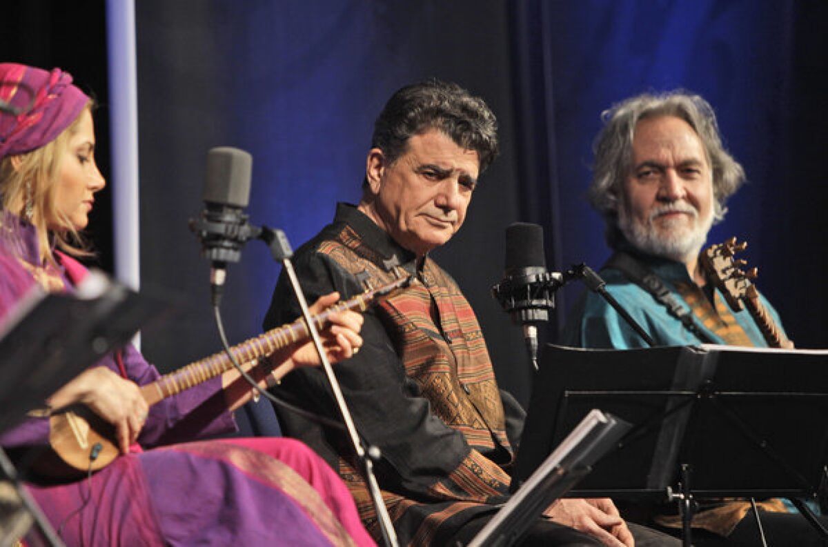 Iran's master of Persian classical music, Mohammad Reza Shajarian, center, performs during a 2011 concert in Dubai