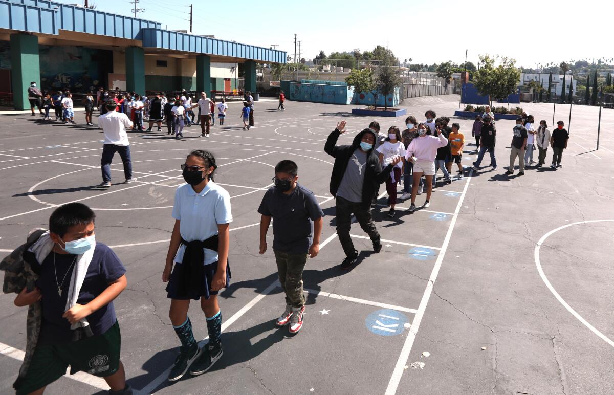 Children line up to return to class after their morning recess.