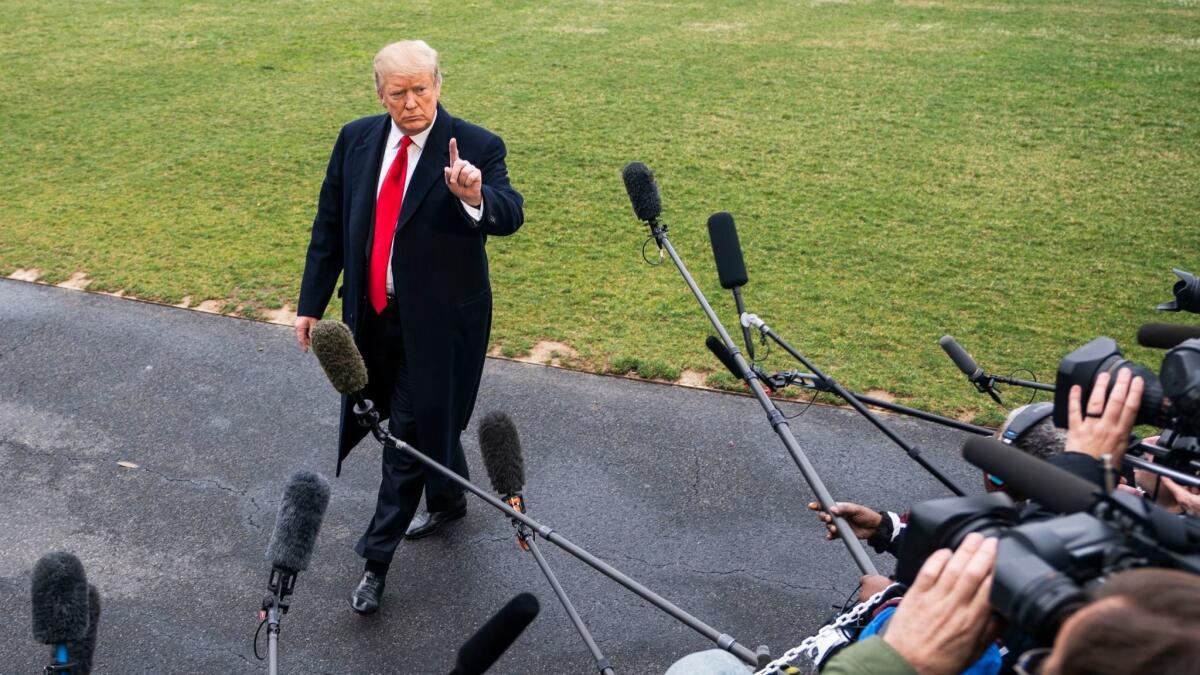 President Trump speaks to the media as he departs the White House for his Mar-a-Lago resort in Florida on March 22.
