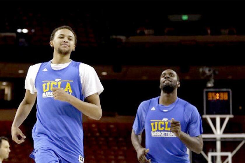 UCLA's Kyle Anderson runs with Shabazz Muhammad during practice for a second-round game of the NCAA college basketball tournament against the Minnesota Golden Gophers.