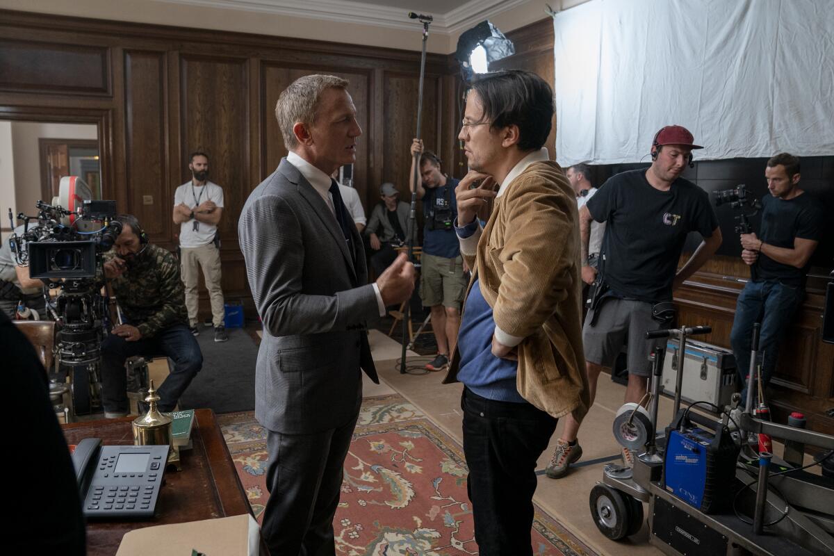 Daniel Craig (James Bond) and director Cary Joji Fukunaga talk on the set of 'No Time to Die.'