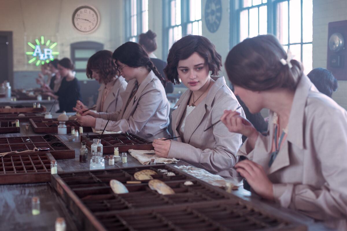 Joey King and other women use paintbrushes in a factory in "Radium Girls."