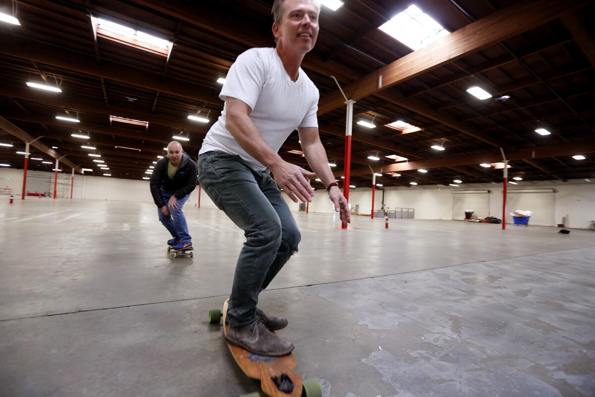 Patterson and Harris getting in some fun before manufacturing equipment arrives to ruin their skateboard rink.
