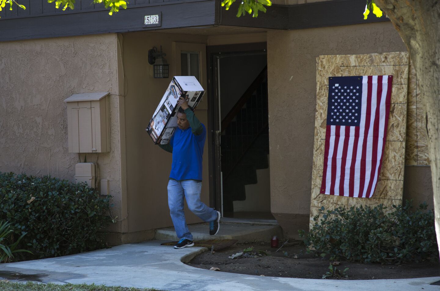A hired mover carries out personal items from the home of San Bernardino shooters Syed Rizwan Farook and Tashfeen Malik.