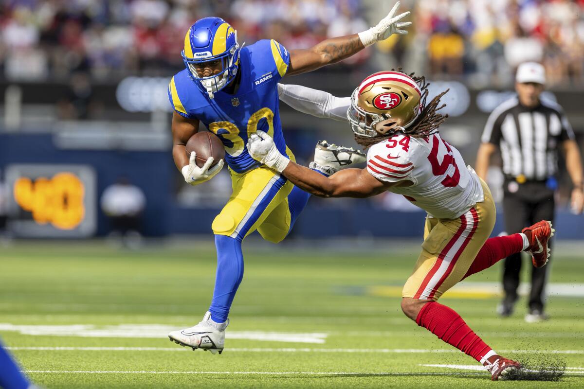 Rams running back Ronnie Rivers is tackled by 49ers linebacker Fred Warner during the second half.