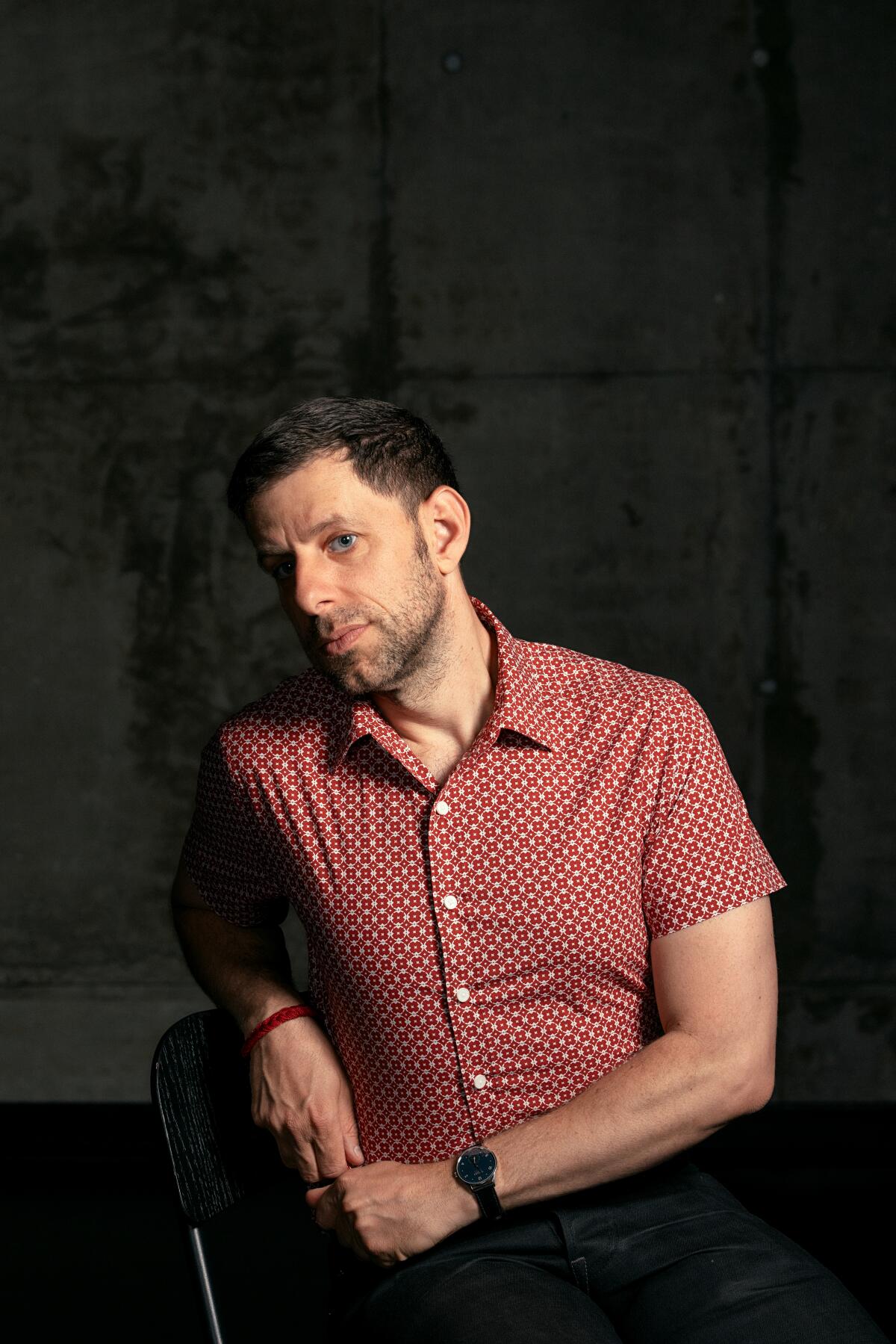 Opera director Yuval Sharon in a red patterned shirt