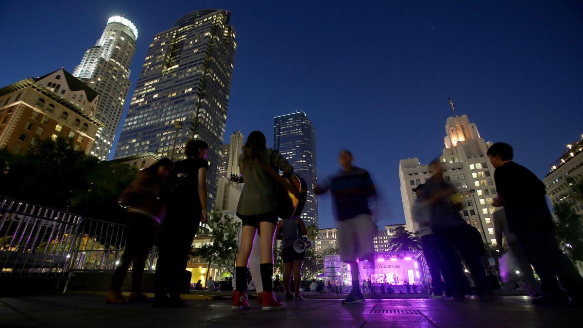 A concert draws a small crowd as dusk descends Pershing Square in 2014.
