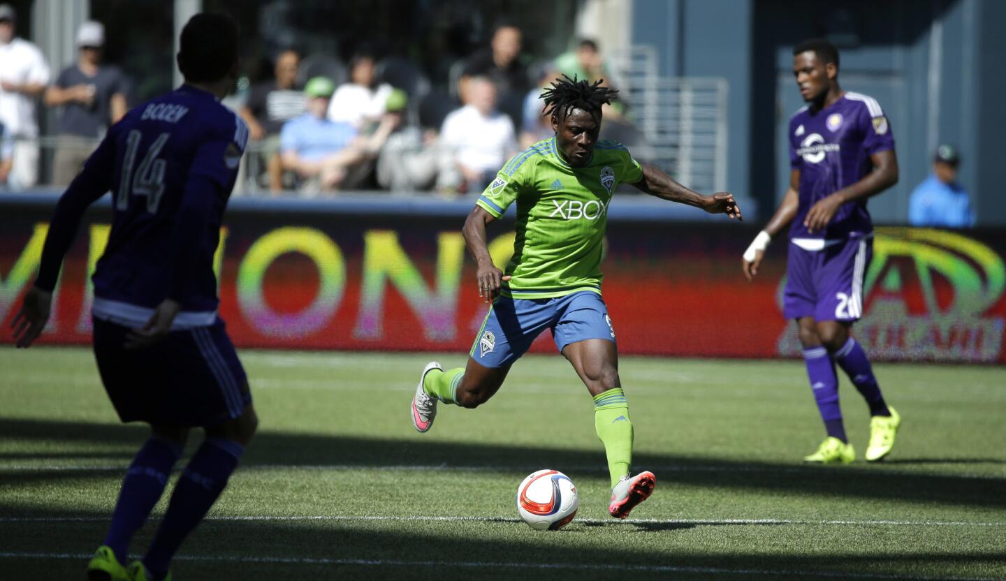 Seattle Sounders' Obafemi Martins, center, kicks the ball against Orlando City in the second half of an MLS soccer match, Sunday, Aug. 16, 2015, in Seattle. The Sounders won 4-0. (AP Photo/Ted S. Warren)
